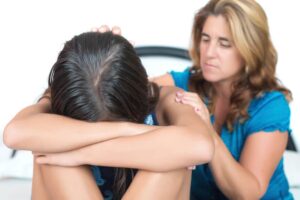 Mother comforting daughter