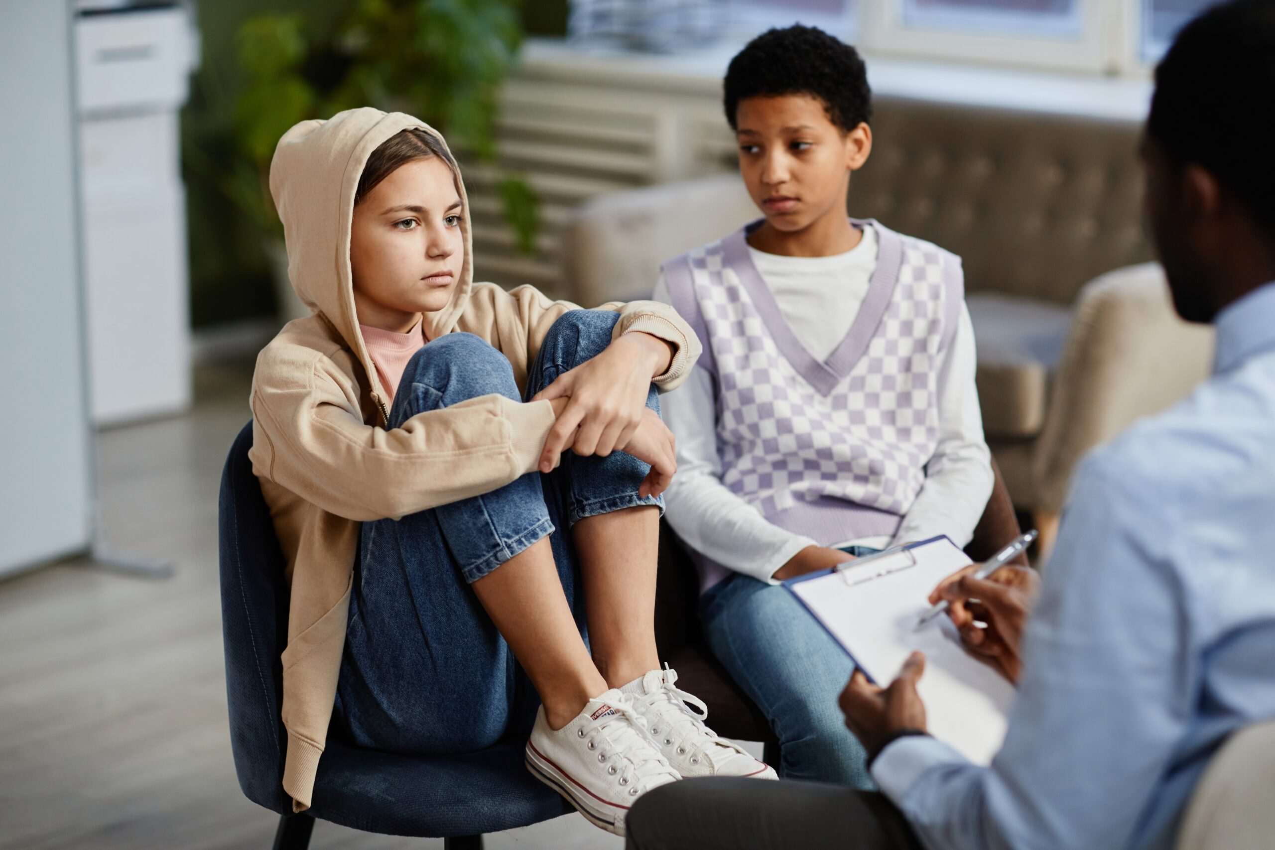 Portrait,Of,Teenage,Girl,Wearing,Hoodie,In,Group,Therapy,Session