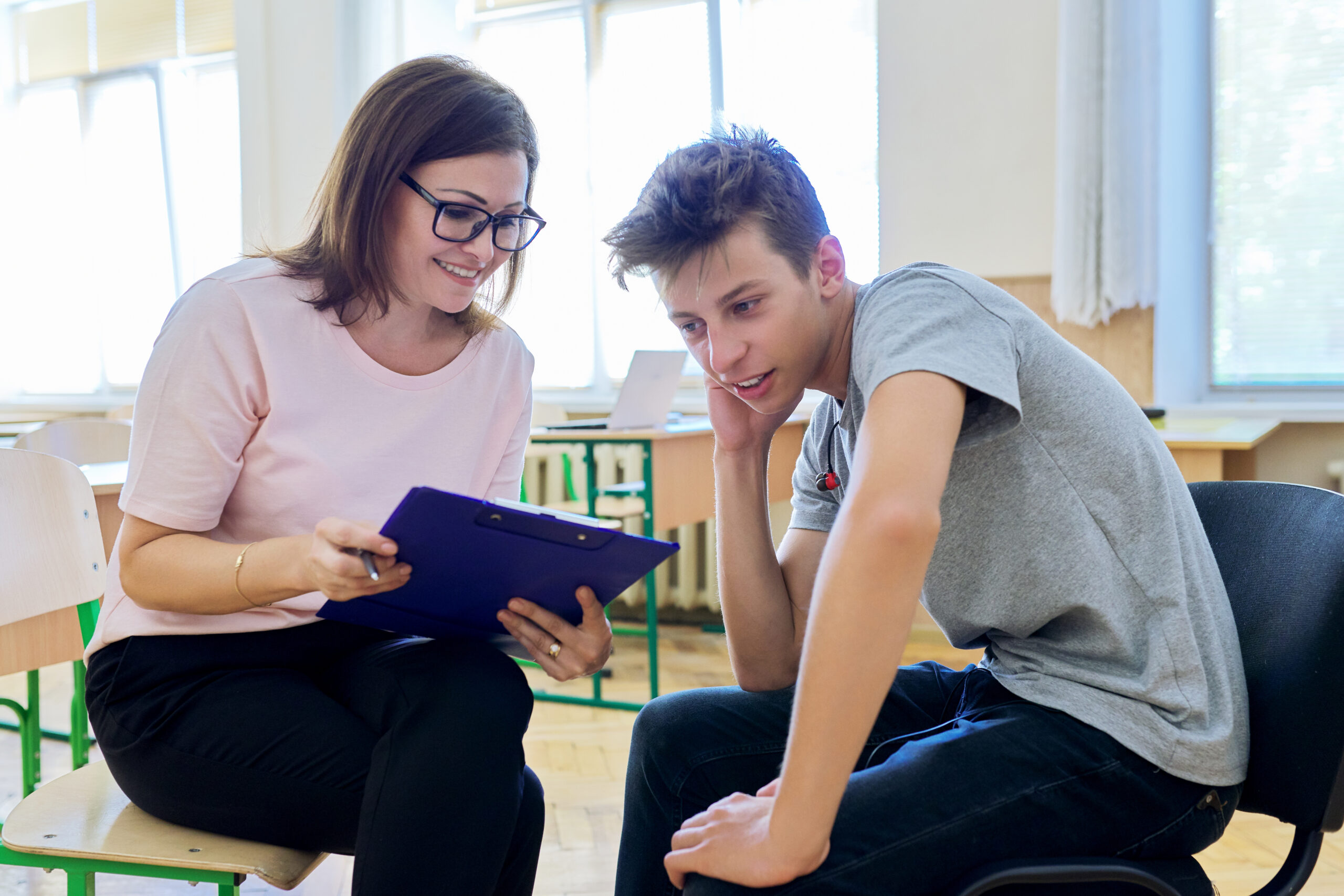 Woman,School,Psychologist,Talking,And,Helping,Student,,Teenage,Boy.,Mental school psychologist talking to student