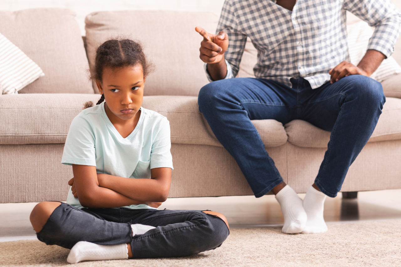 father standing over his child showing what it is to be a helicopter parent