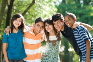 group of teens embracing after getting support therapy for teen brain development