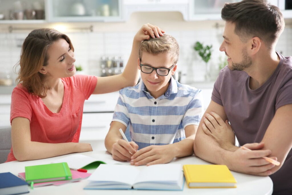 parents supporting teen with schoolwork