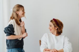teen and mother smiling together