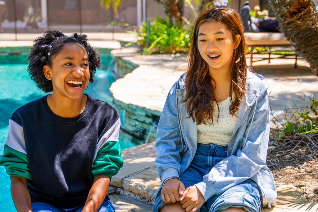 teens outside next to pool