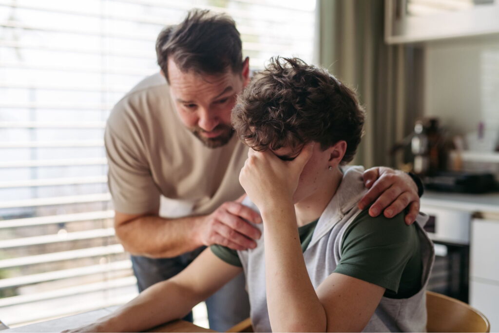 parent of troubled teenager comforts his child