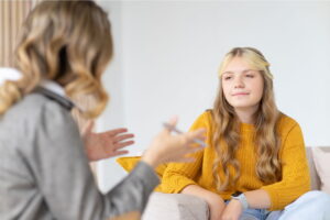 teen girl talking to therapist during mental health treatment
