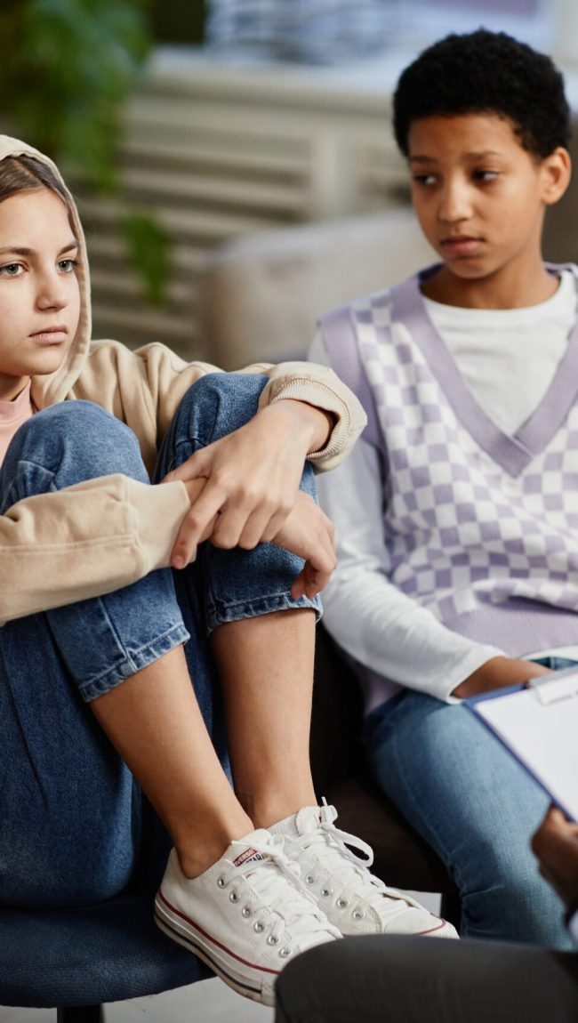 Portrait,Of,Teenage,Girl,Wearing,Hoodie,In,Group,Therapy,Session